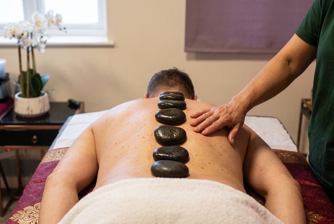 Warm basalt stones placed along a client's spine